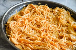 Family size pan full of spaghetti noodles covered in Mexican tomato cream sauce