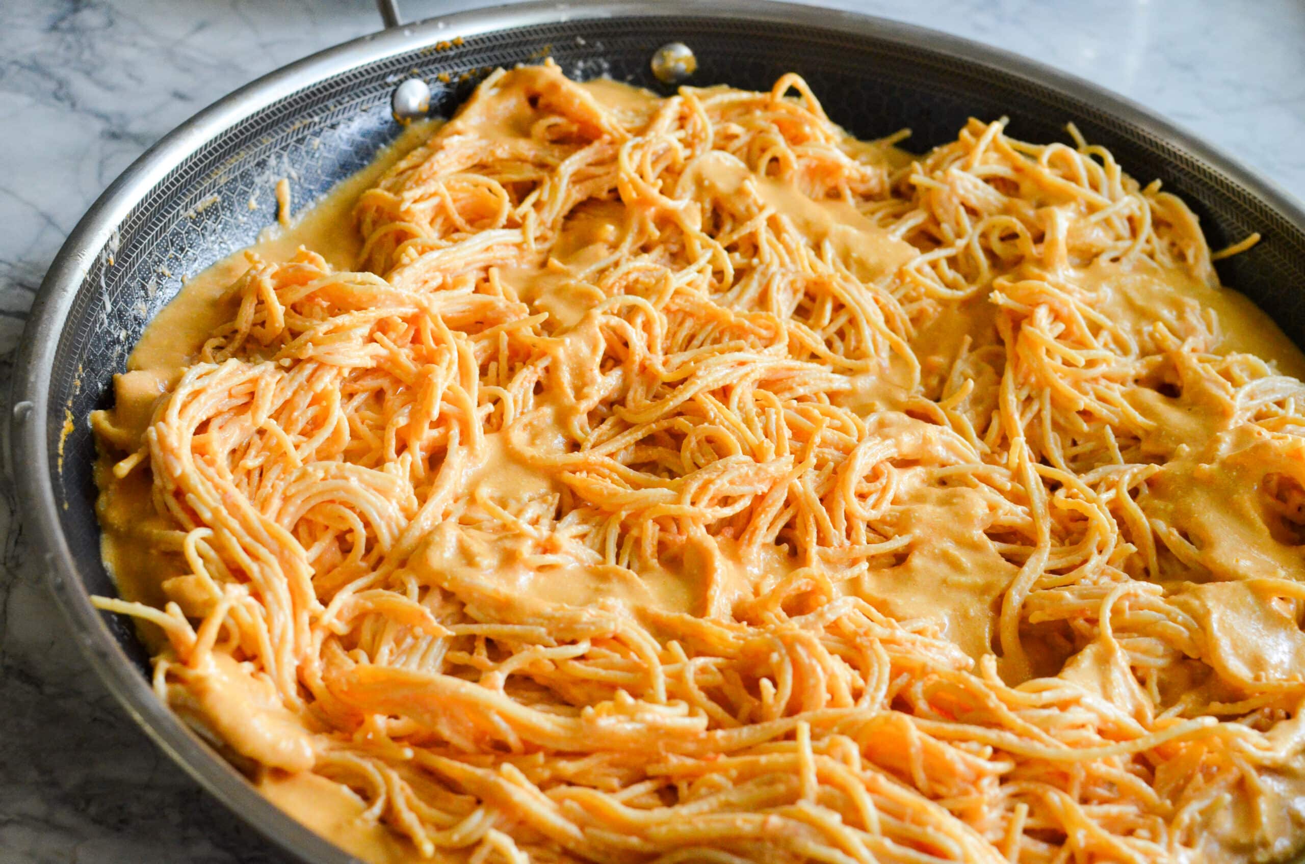 Family size pan full of spaghetti noodles covered in Mexican tomato cream sauce